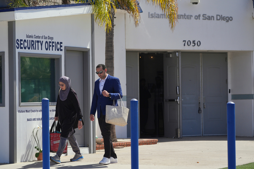 People walk outside of the Islamic Center of San Diego, the day after a shooting, Tuesday, May 19, 2026, in San Diego. (AP Photo/Jae C. Hong)