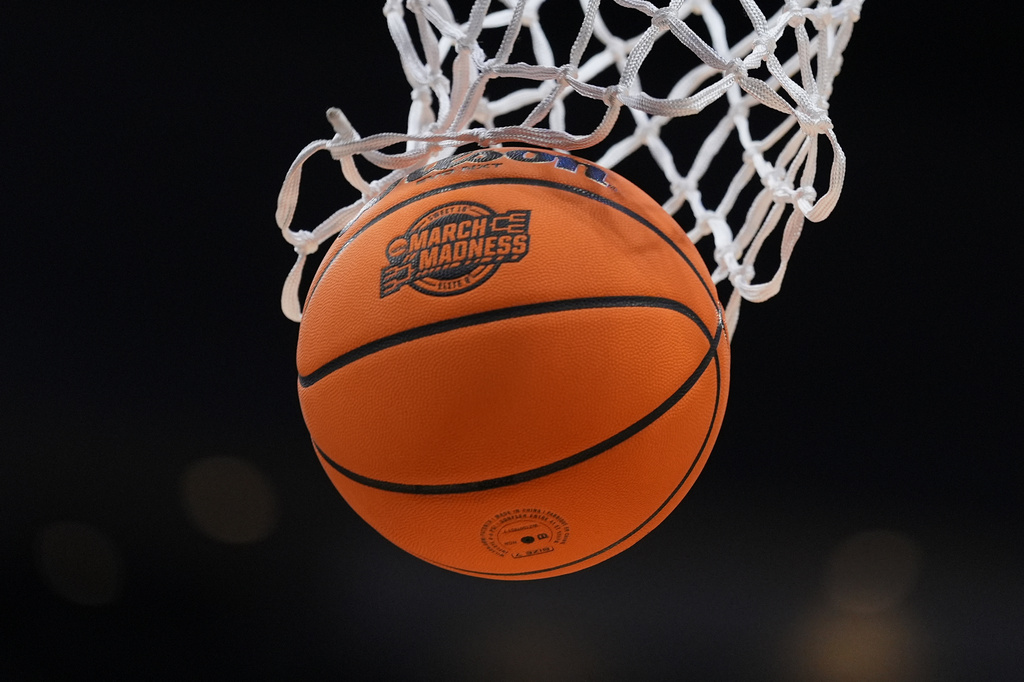 FILE - A basketball goes throw the net before an Elite Eight game between Iowa and Illinois in the NCAA college basketball tournament Saturday, March 28, 2026, in Houston. (AP Photo/Eric Gay, File)