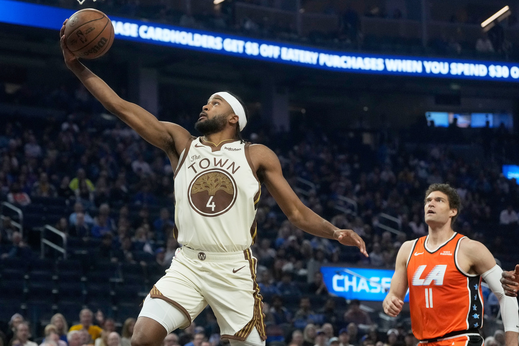 Golden State Warriors guard Moses Moody (4) shoots against Los Angeles Clippers center Brook Lopez (11) during the first half of an NBA basketball game in San Francisco, Monday, March 2, 2026. (AP Photo/Jeff Chiu)