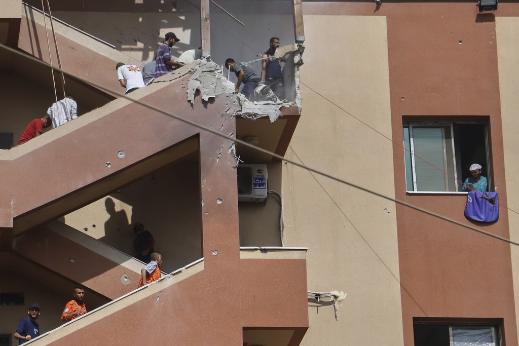 People walk up the stairs to the site of an Israeli strike, minutes before a second strike hit the same spot, killing at least 22 people in total, including five journalists, at Nasser Hospital in Khan Younis, southern Gaza Strip, Monday, Aug. 25, 2025. This was one of the last photos taken by journalist Mariam Dagga, who freelanced for The Associated Press and other outlets, before she walked to the site and was killed in the second strike. (AP Photo/Mariam Dagga)