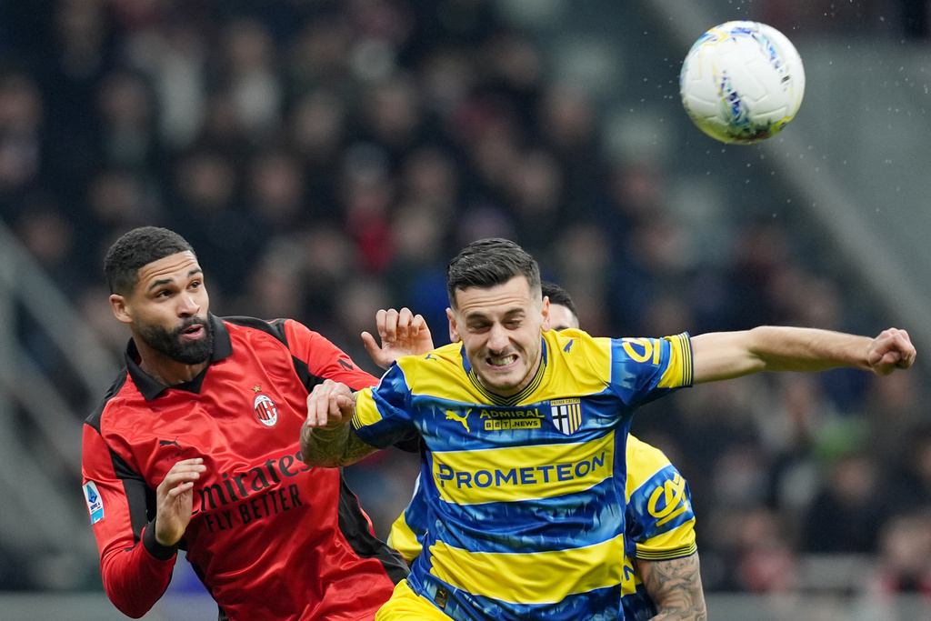AC Milan's Ruben Loftus-Cheek, left, fights for the bass with Parma's Emanuele Valeri during the Italian Serie A soccer match between AC Milan and Parma in Milan, Italy, Sunday, Feb. 22 , 2025. (Spada/LaPresse via AP)