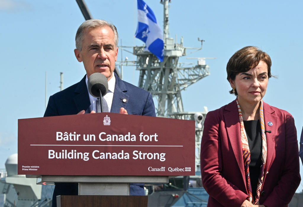 Canadian Prime Minister Mark Carney speaks as he announces a $11.3 billion contract for icebreakers at the Davie shipyard in Levis, Quebec on Monday, Aug. 24, 2026. Quebec Premier Christine Frechette, right, looks on. (Jacques Boissinot/The Canadian Press via AP)