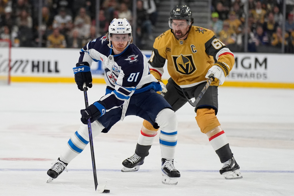 Winnipeg Jets left wing Kyle Connor (81) skates against Vegas Golden Knights right wing Mark Stone (61) during the first period of an NHL hockey game Monday, April 13, 2026, in Las Vegas. (AP Photo/John Locher)