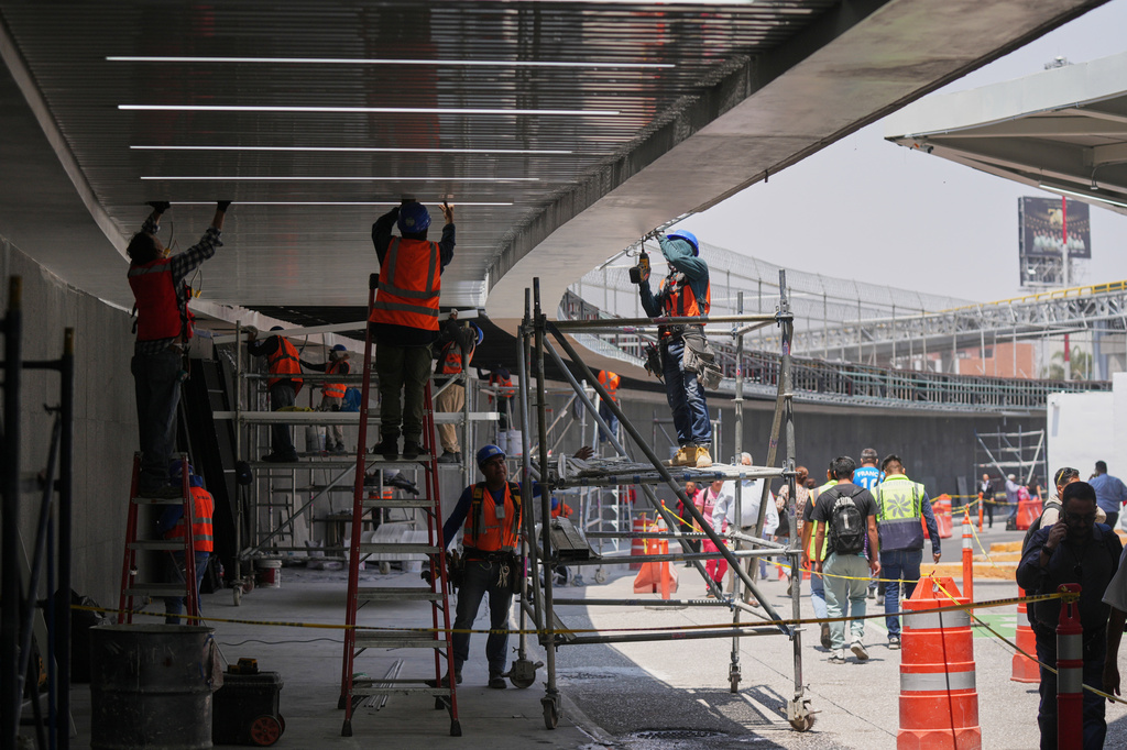 Workers repair the ceiling of the Terminal 1 during a guided media tour of the renovation work at Benito Juárez International Airport, in preparation for the 2026 World Cup in Mexico City, on Tuesday, May 19, 2026. (AP Photo/Fernando Llano)