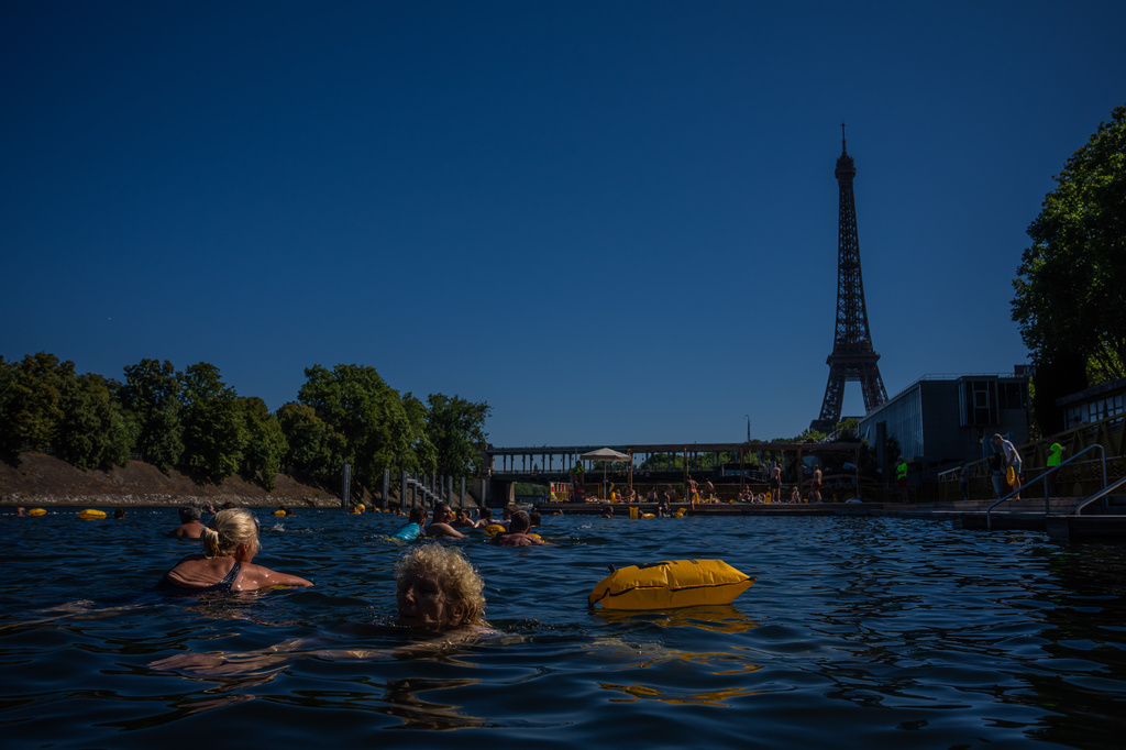 People swim in the Seine River, Saturday, July 4, 2026 in Paris. (AP Photo/Aurelien Morissard)