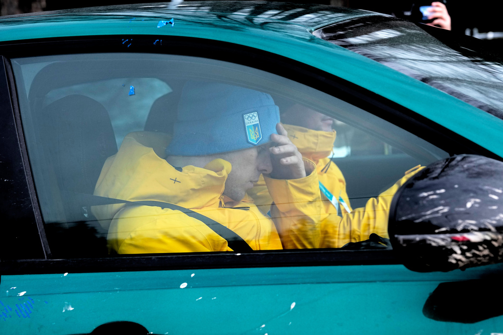 Ukrainian skeleton athlete Vladyslav Heraskevych sits in a car at the sliding center at the 2026 Winter Olympics, in Cortina d'Ampezzo, Italy, Thursday, Feb. 12, 2026. (AP Photo/Alessandra Tarantino)