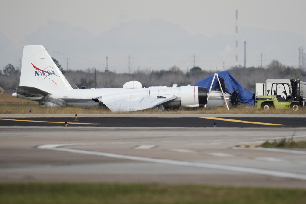 A NASA aircraft sits near a runway at Ellington Airport after making a belly landing on Tuesday, Jan. 27, 2026, in Houston. (AP Photo/Ashley Landis)