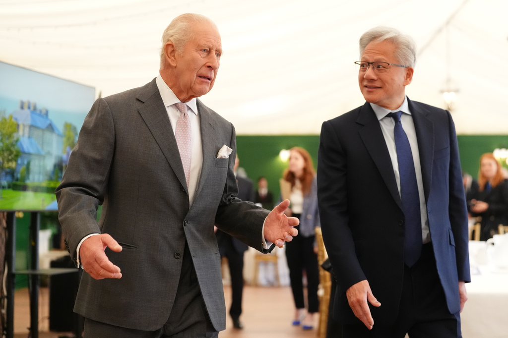 Britain's King Charles III, left, walks with Nvidia chief executive Jensen Huang to a meeting for leaders from the artificial intelligence (AI) sector, government, and thought leaders to discuss how AI can be developed and deployed in ways that benefit society, at Dumfries House in Cumnock, Scotland, Thursday Sept. 17, 2026. (Jonathan Brady/PA via AP, Pool)
