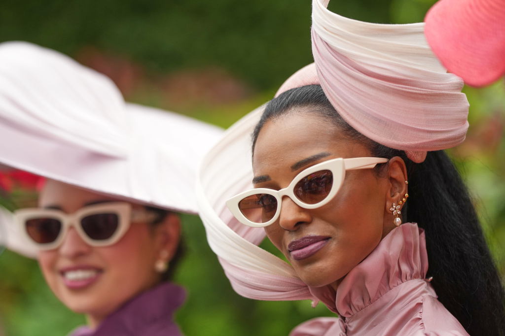 Racegoer Lovely Amusan, right, poses for a picture as she arrives on the third day of the Royal Ascot horse race meeting, traditionally called Ladies Day in Ascot, England, Thursday, June 18, 2026. (AP Photo/Alastair Grant)