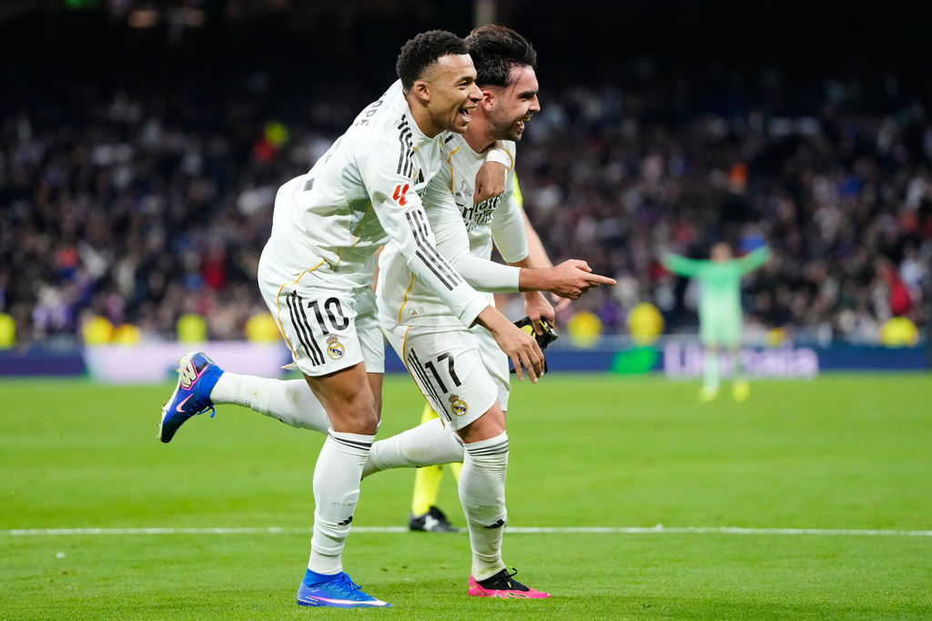 Real Madrid's Raul Asencio, right, celebrates with teammate Kylian Mbappe after scoring his side's second goal during the Spanish La Liga soccer match between Real Madrid and Levante in Madrid, Spain, Saturday, Jan. 17, 2026. (AP Photo/Jose Breton)