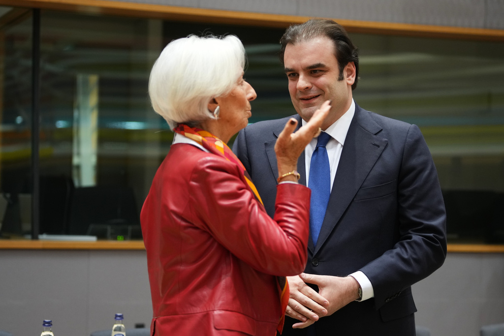 European Central Bank President Christine Lagarde, left, speaks with Greece's Finance Minister Kyriakos Pierrakakis during a meeting of eurozone finance ministers at the EU Council building in Brussels, Thursday, Dec. 11, 2025. (AP Photo/Virginia Mayo)