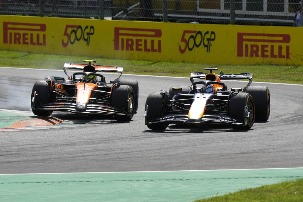 Red Bull driver Max Verstappen of the Netherlands, left, overtakes McLaren driver Lando Norris of Britain during the Italian Grand Prix race at the Monza racetrack in Monza, Italy, Sunday, Sept. 7, 2025. (AP Photo/Luca Bruno)