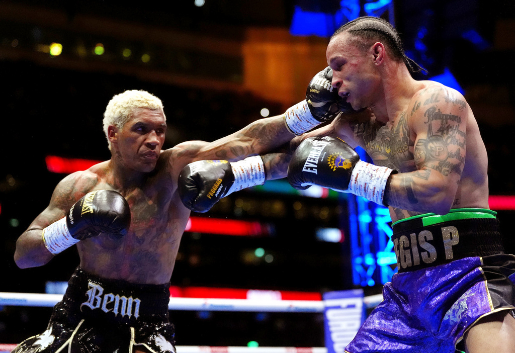 Boxers Conor Benn, left, and Regis Prograis battle during a welterweight bout at Tottenham Hotspur Stadium in London, Saturday, April 11, 2026. (Bradley Collyer/PA via AP)