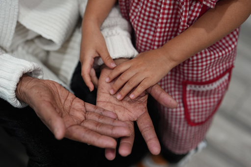 A girl touches her grandmother's hand inside Luna y Cielo Play Cafe where children learn and practice the Spanish language through play in Chicago's Logan Square neighborhood, Wednesday, Oct. 15, 2025. (AP Photo/Rebecca Blackwell) A girl touches her grandmother's hand inside Luna y Cielo Play Cafe where children learn and practice the Spanish language through play in Chicago's Logan Square neighborhood, Wednesday, Oct. 15, 2025. (AP Photo/Rebecca Blackwell)
