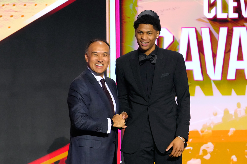 Meleek Thomas, right, poses for a photo with NBA Deputy Commissioner Mark Tatum after being selected by the Cleveland Cavaliers in the second round of the NBA basketball draft Wednesday, June 24, 2026, in New York. (AP Photo/Yuki Iwamura)