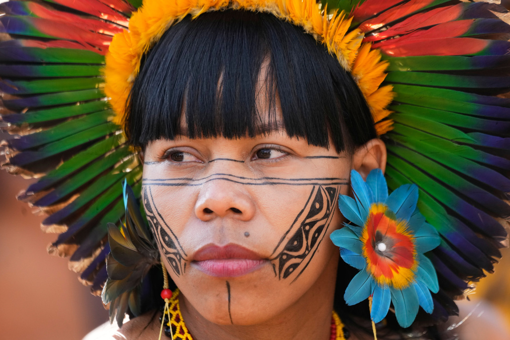 A Xakriaba Indigenous woman attends a march during the annual "Acampamento Terra Livre," or Free Land Encampment, Brazil's largest annual Indigenous mobilization that focuses on land rights and environmental protection, in Brasilia, Brazil, Tuesday, April 7, 2026. (AP Photo/Eraldo Peres)