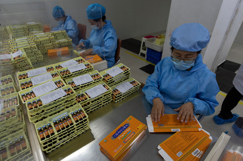 Workers pack traditional Tibetan medicine produced by the Xizang Gansu Tibetan Medicine Co. Ltd in Lhasa, in western China's Tibet Autonomous Region on Wednesday, July 22, 2026 as seen during a government organized visit for foreign journalists. (AP Photo/Ng Han Guan)