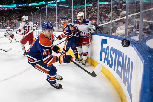 New York Rangers' Urho Vaakanainen (18) and Edmonton Oilers' Andrew Mangiapane (88) battle as Oilers' Troy Stecher (51) goes after the puck during third-period NHL hockey game action in Edmonton, Alberta, Thursday, Oct. 30, 2025. (Jason Franson/The Canadian Press via AP) New York Rangers' Urho Vaakanainen (18) and Edmonton Oilers' Andrew Mangiapane (88) battle as Oilers' Troy Stecher (51) goes after the puck during third-period NHL hockey game action in Edmonton, Alberta, Thursday, Oct. 30, 2025. (Jason Franson/The Canadian Press via AP)