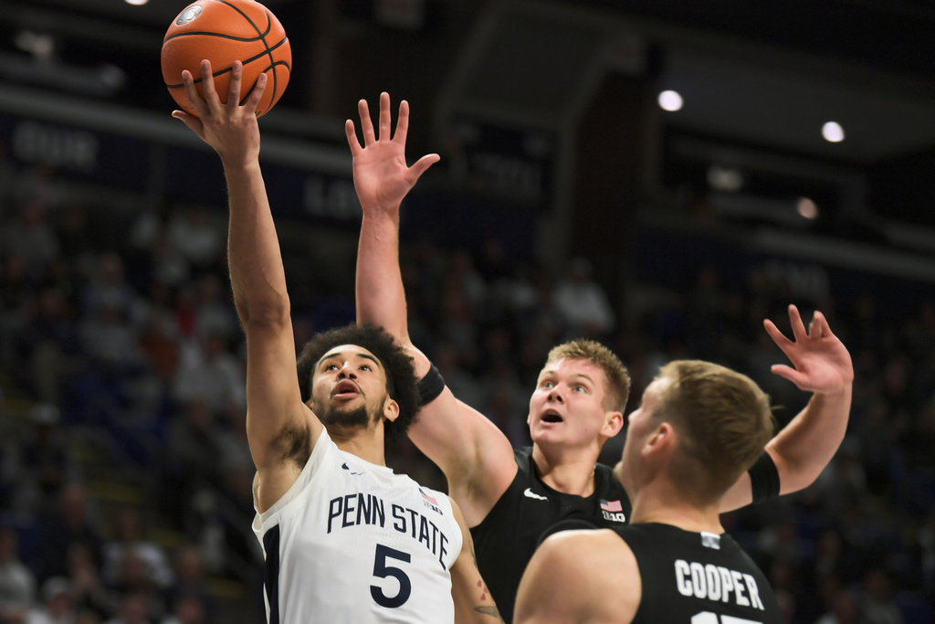 Michigan State's Jaxon Kohler, center, and Carson Cooper (15) attempt to block a shot by Penn State's Freddie Dilione V (5) during the first half of an NCAA college basketball game Saturday, Dec. 13, 2025, in State College, Pa. (AP Photo/Gary M. Baranec)