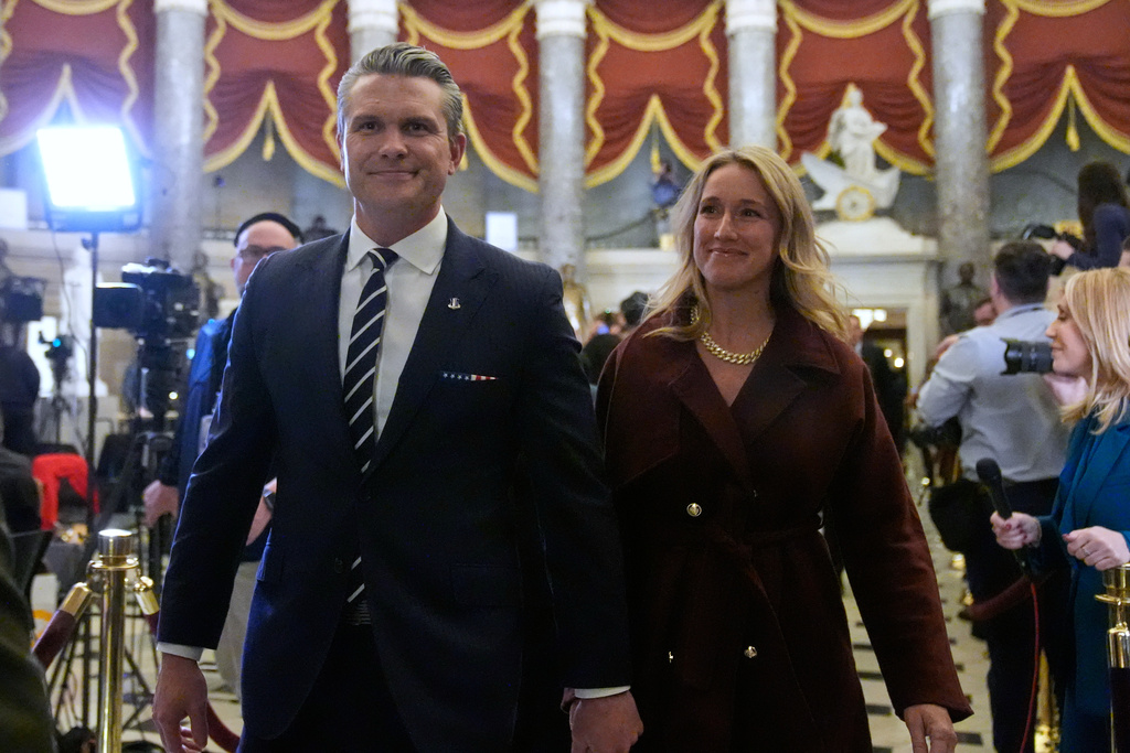 Defense Secretary Pete Hegseth and his wife Jennifer Rauchet arrive before President Donald Trump delivers the State of the Union address to a joint session of Congress in the House chamber at the U.S. Capitol in Washington, Tuesday, Feb. 24, 2026. (AP Photo/Mark Schiefelbein)