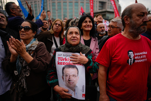 People listen to speeches during a rally in support of Istanbul's imprisoned opposition Mayor Ekrem Imamoglu as he appears for a hearing at the Caglayan courthouse, in Istanbul, Turkey, Sunday, Oct. 26, 2025. The poster with the photo of Imamoglu reads in Turkish: "Turkey will win". (AP Photo/Emrah Gurel) People listen to speeches during a rally in support of Istanbul's imprisoned opposition Mayor Ekrem Imamoglu as he appears for a hearing at the Caglayan courthouse, in Istanbul, Turkey, Sunday, Oct. 26, 2025. The poster with the photo of Imamoglu reads in Turkish: "Turkey will win". (AP Photo/Emrah Gurel)