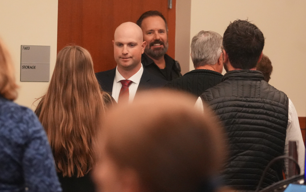 Blendon Township police officer Connor Grubb greets a family member Friday, Nov. 21, 2025 after the not guilty verdict is read at Franklin County Common Pleas Court in Columbus, Ohio on Friday, Nov. 21, 2025. (Doral Chenoweth/The Columbus Dispatch via AP, Pool)