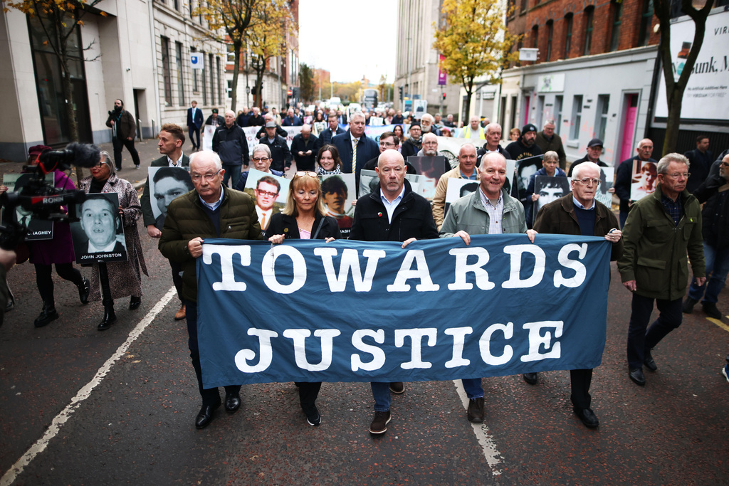 Relatives and supporters of the victims of the 1972 Bloody Sunday massacre march to Belfast Crown Court ahead of the verdict on the trial of a British soldier identified only as Soldier F, Belfast, in Northern Ireland, Thursday, Oct. 23, 2025. (AP Photo/Peter Morrison)