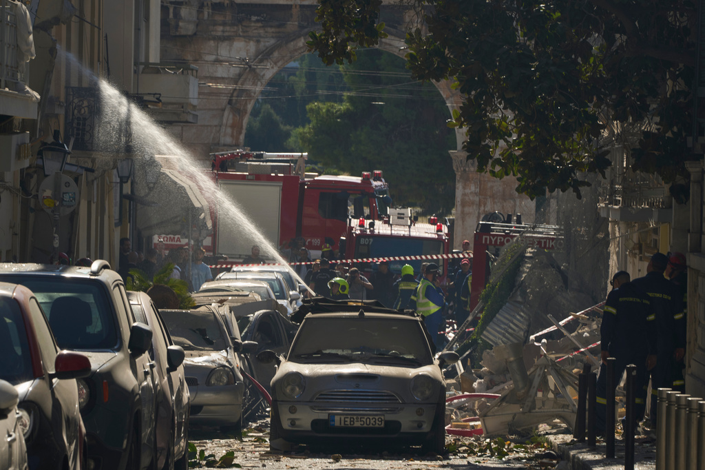 Firefighters work at the scene following a powerful blast that caused a building to collapse and injured at least two people in Athens' Plaka district, with the ancient Hadrian's Arch in the background, Friday, Sept. 25, 2026. (AP Photo/Petros Giannakouris)