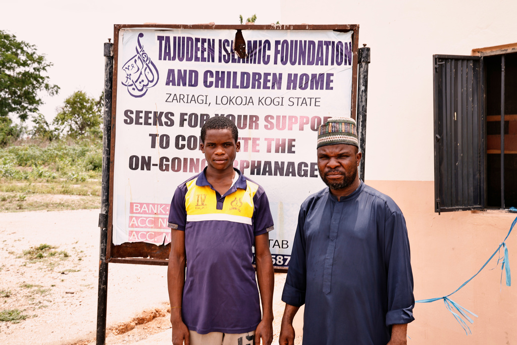 A student from an orphanage school that was abducted with others by gunmen in late April, is photograph with, Tajudeen M.S, right, the proprietor of the school, following his released in Lokoja, Nigeria, Thursday, May 7, 2026. (AP Photo/Haruna Yahaya)