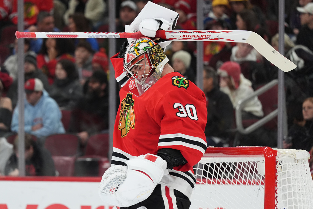 Chicago Blackhawks goaltender Spencer Knight adjusts his helmet during the first period of an NHL hockey game against the Dallas Stars in Chicago, Thursday, Jan. 1, 2026. (AP Photo/Nam Y. Huh)