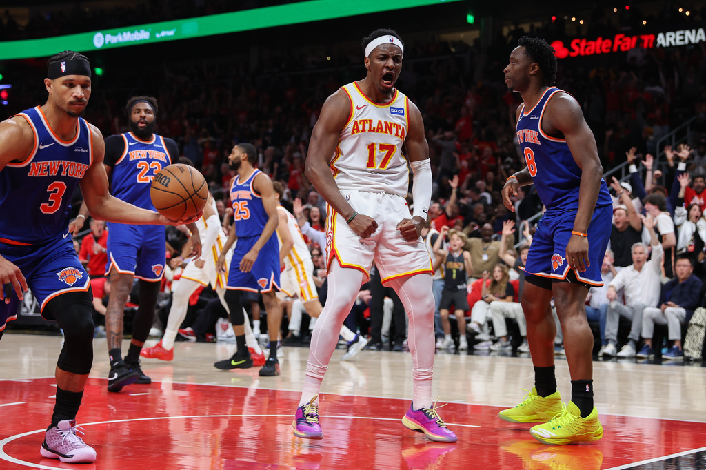 Atlanta Hawks forward Onyeka Okongwu (17) reacts after a dunk against New York Knicks guard Josh Hart (3) and forward Og Anunoby (8) during the first half in Game 3 of a first-round NBA playoffs basketball series, Thursday, April 23, 2026, in Atlanta. (AP Photo/Colin Hubbard)