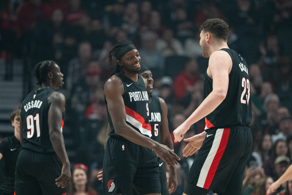 Portland Trail Blazers guard Sidy Cissoko (91), forward Jerami Grant (9), and center Donovan Clingan (23) react after a call during the first half of an NBA basketball game against the Memphis Grizzlies on Saturday, Feb. 7, 2026, in Portland, Ore. (AP Photo/Ali Gradischer)