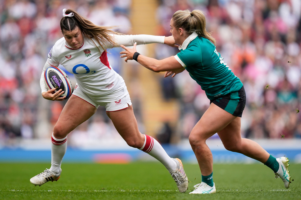 England's Jess Breach, left, and Ireland's Stacey Flood in action during the Women's Six Nations Rugby 2026 match, in London, Saturday, April 11, 2026. (Andrew Matthews/PA via AP)