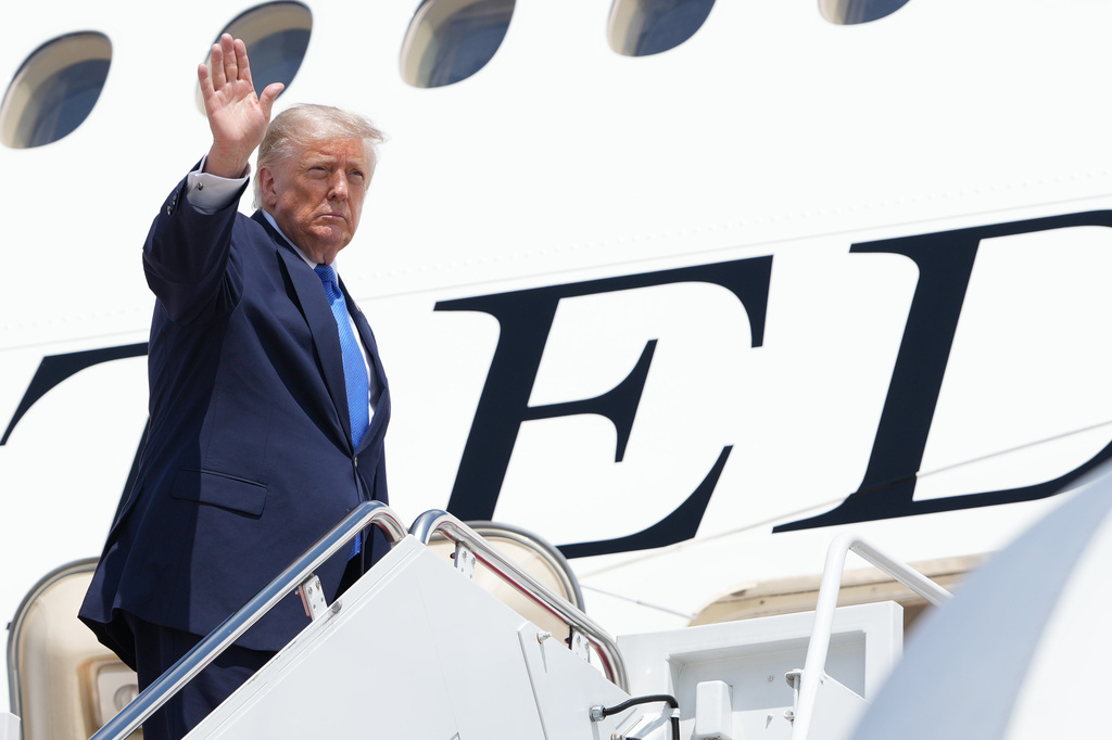President Donald Trump boards Air Force One, Tuesday, Aug. 4, 2026, at Joint Base Andrews, Md. (AP Photo/Mark Schiefelbein)