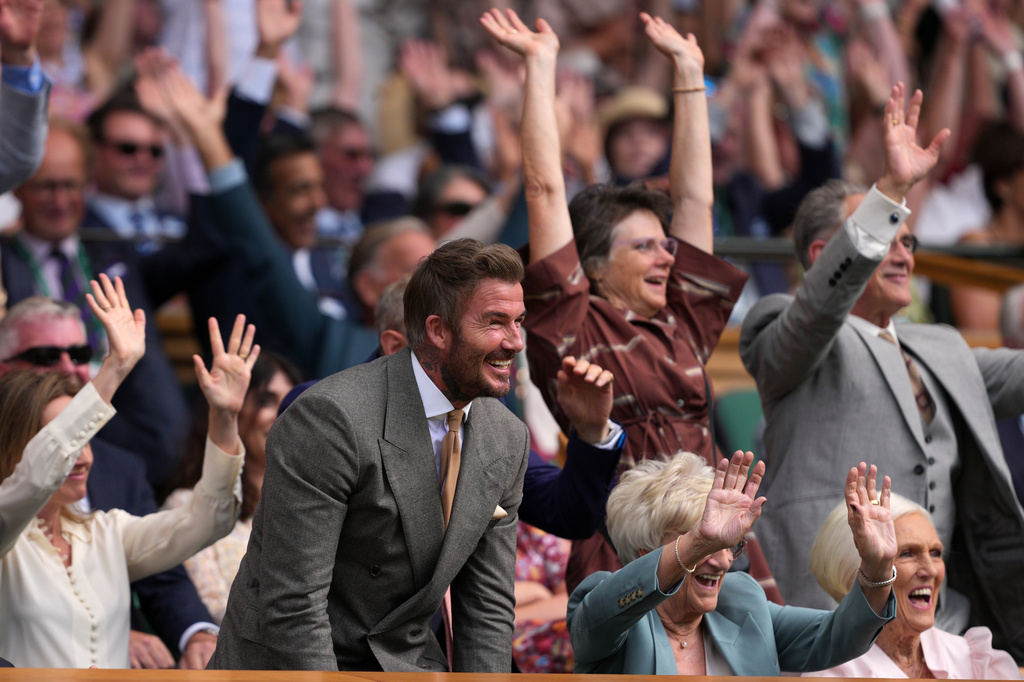 Soccer legend David Beckham and his mother Sandra Georgina Beckham react during the men's singles match between Jannik Sinner of Italy and Miomir Kecmanovic of Serbia at the Wimbledon Tennis Championships in London, Monday, June 29, 2026.((AP Photo/Kin Cheung)