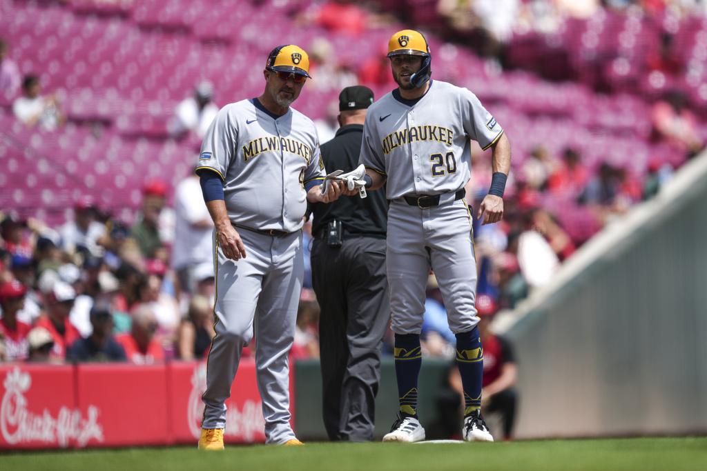 Milwaukee Brewers' Brandon Lockridge (20) stands on base after hitting a triple in the third inning of a baseball game against the Cincinnati Reds, Sunday, Aug. 17, 2025, in Cincinnati. (AP Photo/Grace Bradley)
