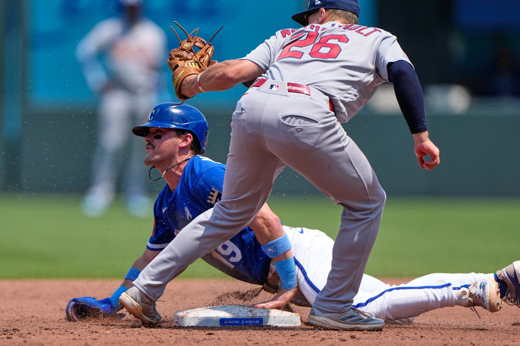 Kansas City Royals' Michael Massey (19) beats the tag by St. Louis Cardinals second baseman JJ Wetherholt to steal second during the third inning of a baseball game Sunday, June 21, 2026, in Kansas City, Mo. (AP Photo/Charlie Riedel)