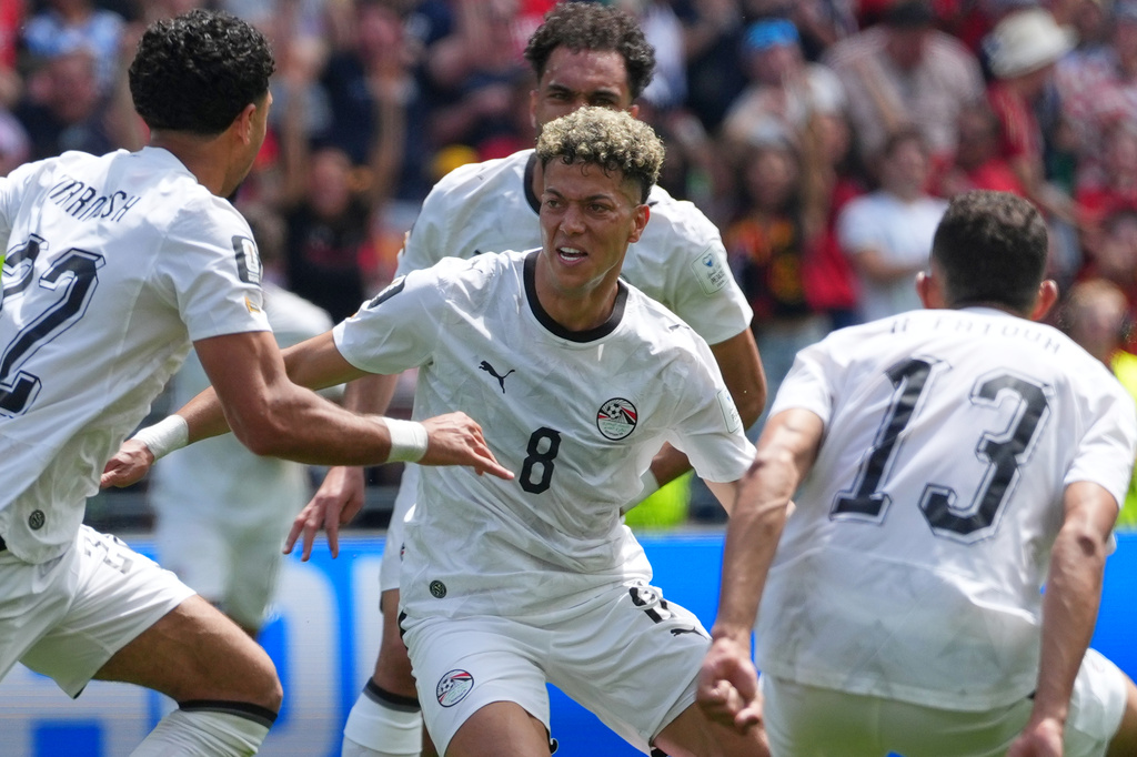 Egypt's Emam Ashour, centre celebrates with teammates after scoring the opening goal during the World Cup Group G soccer match between Belgium and Egypt in Seattle, Monday, June 15, 2026. (AP Photo/Manu Fernandez)