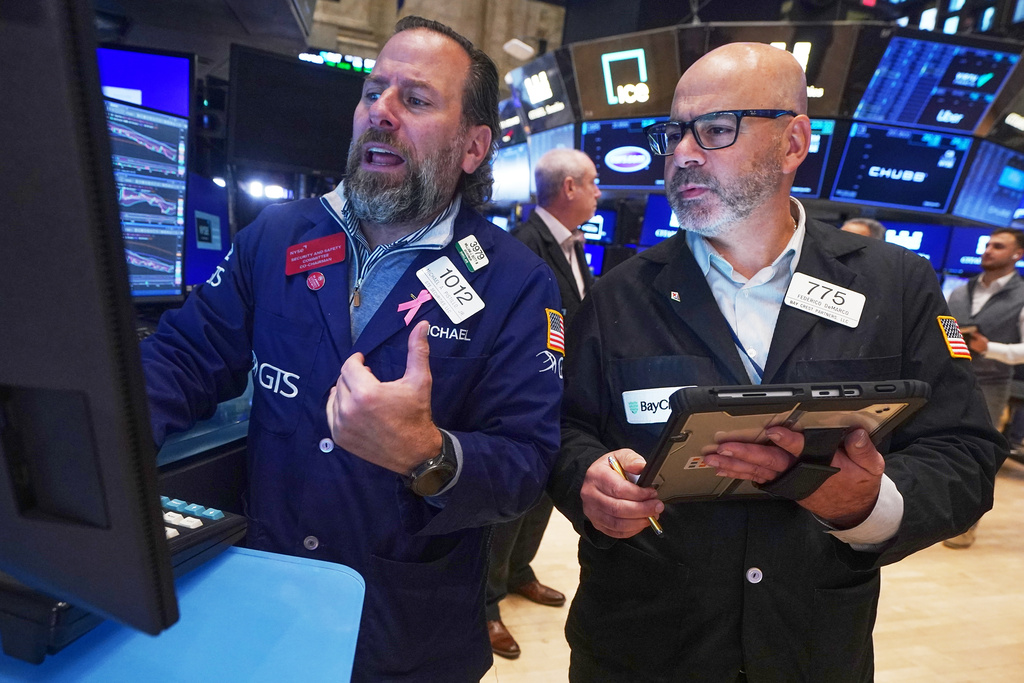 Specialist Michael Pistillo, left, and trader Fred Demarco work on the floor of the New York Stock Exchange, Thursday, Nov. 20, 2025. (AP Photo/Richard Drew)