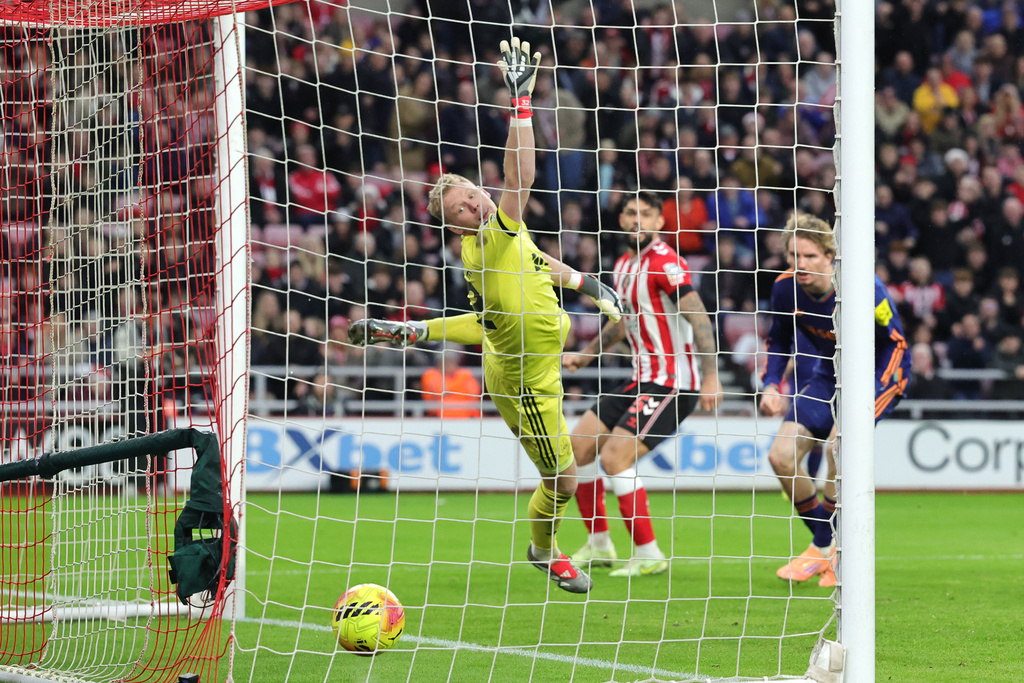 Newcastle United's Nick Woltemade scores Sunderland's first goal of the game, via an own goal during their English Premier League soccer match in Sunderland, England, Sunday, Dec. 14, 2025. (Steve Welsh/PA via AP)