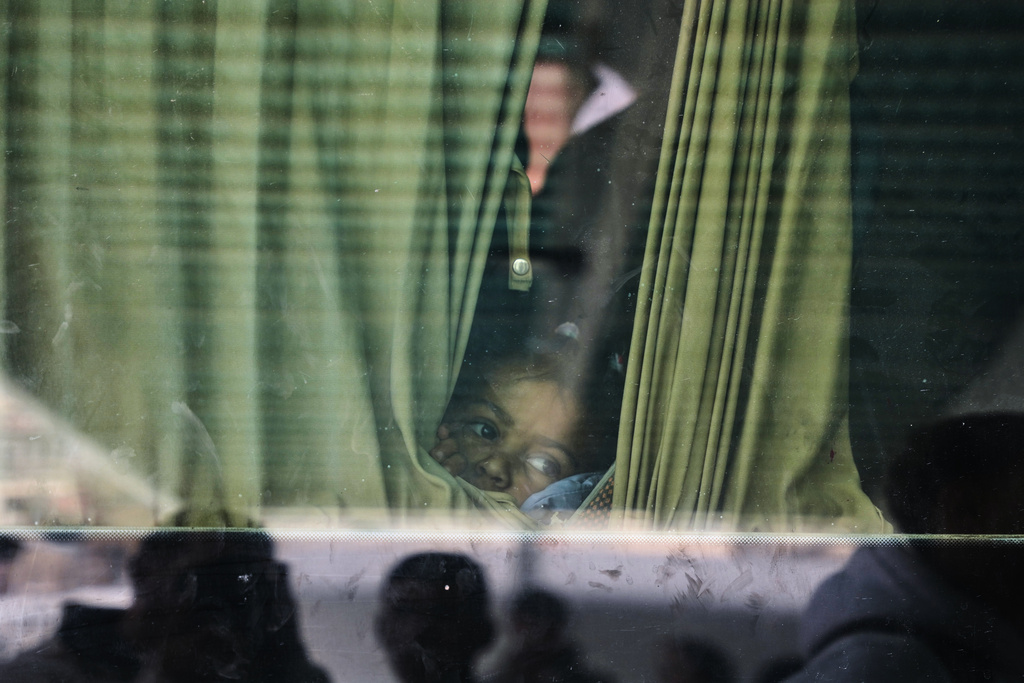Juman Al-Najjar, a 3-year-old Palestinian patient, looks out from a vehicle with other patients in Khan Younis as they head to the Rafah crossing, leaving the Gaza Strip for medical treatment abroad, Monday, Feb. 2, 2026. (AP Photo/Abdel Kareem Hana)