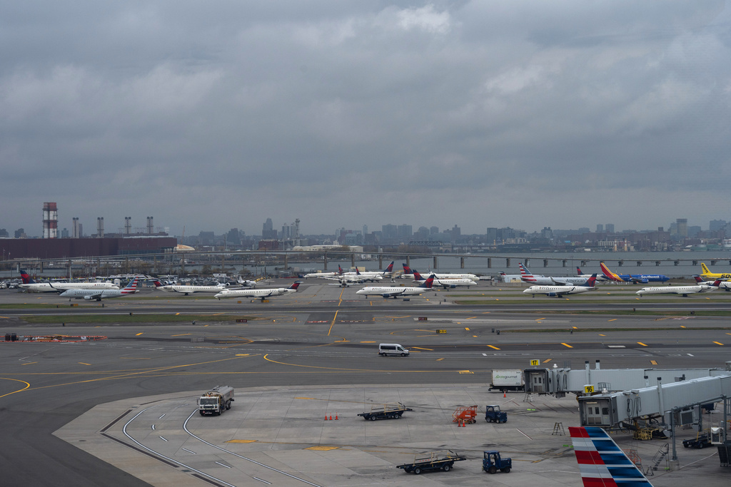 A group of planes wait in line for take off at LaGuardia Airport (LGA), in the Queens borough of New York, Sunday, Nov. 9, 2025. (AP Photo/Adam Gray)