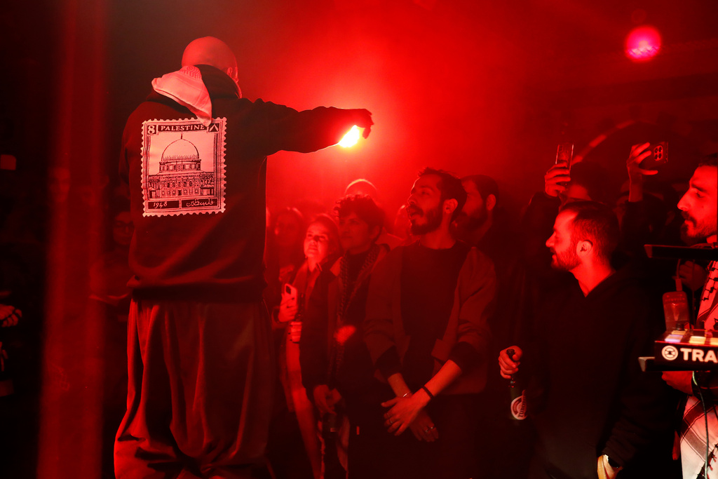 Hani Al Sawah, left, a Syrian rap artist known as Al Darwish, performs at a restaurant in old Damascus, Syria, Friday, Jan. 16, 2026. (AP Photo/Omar Sanadiki)