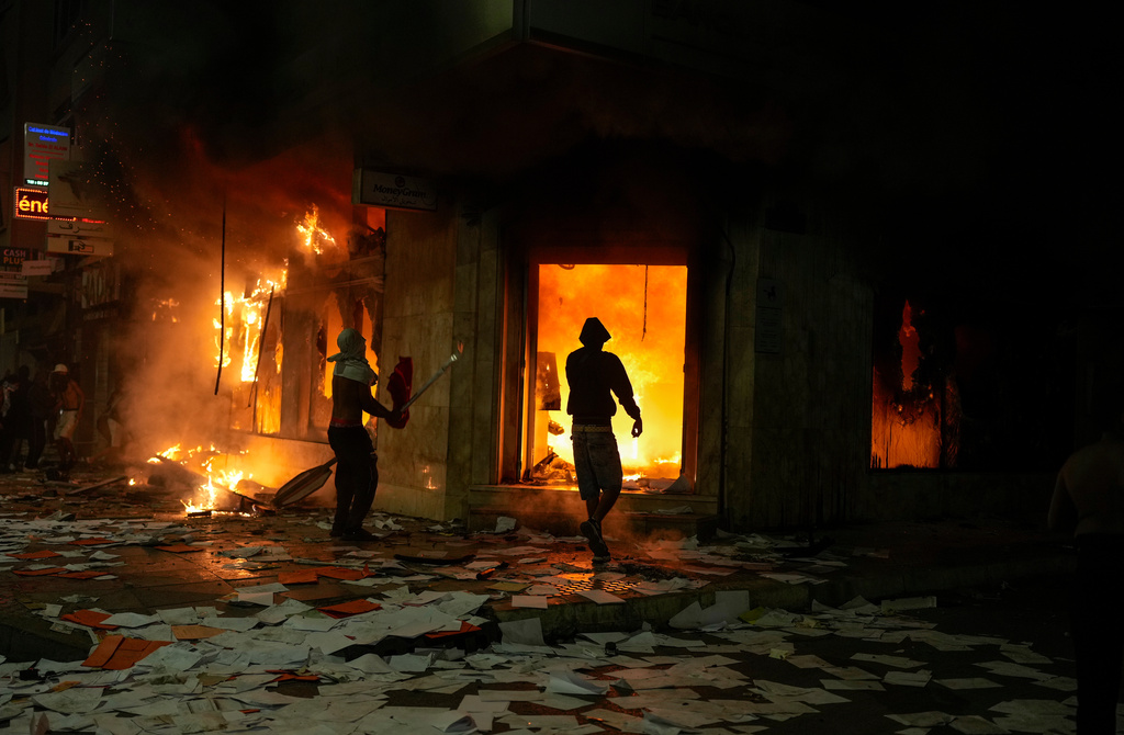 People torch and loot a bank as youth led protests calling for healthcare and education reforms turned violent, in Sale, Morocco, Wednesday, Oct. 1, 2025. (AP Photo/Mosa'ab Elshamy)