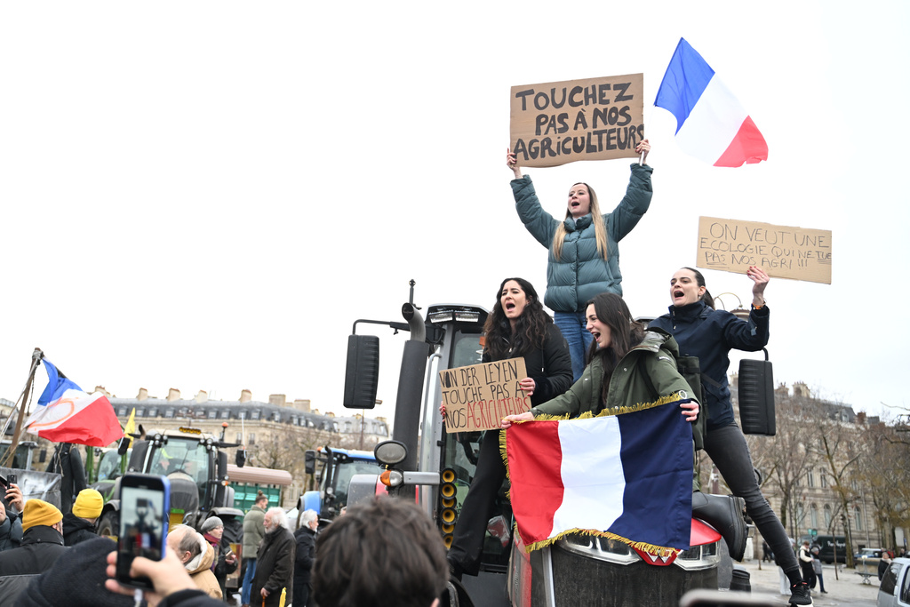 Women atop a tractor support farmers as they protest at the Arc de Triomphe against against the European Union's negotiations over the Mercosur trade deal with five South American nations, Thursday, Jan. 8, 2026 in Paris. (AP Photo/Emma Da Silva)