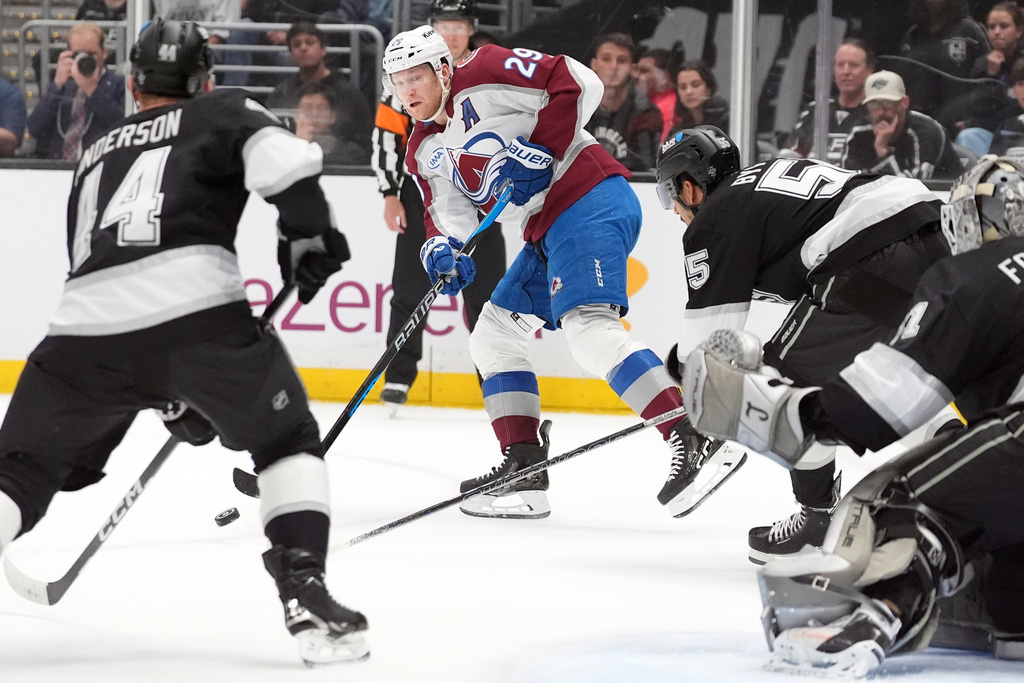 Colorado Avalanche's Nathan MacKinnon (29) passes the puck against the Los Angeles Kings during the first period of Game 4 in the first round of an NHL hockey Stanley Cup playoff series Sunday, April 26, 2026, in Los Angeles. (AP Photo/Scott Strazzante)