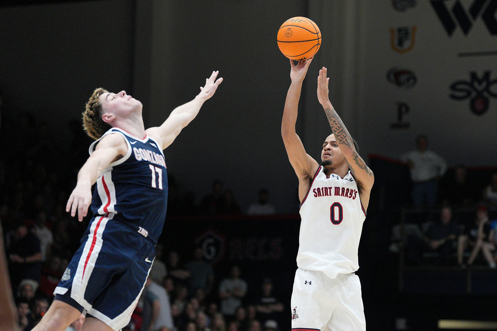 Saint Mary's guard Mikey Lewis (0) shoots over Gonzaga guard Mario Saint-Supery (17) during the second half of an NCAA college basketball game in Moraga, Calif., Saturday, Feb. 28, 2026. (AP Photo/Tony Avelar)