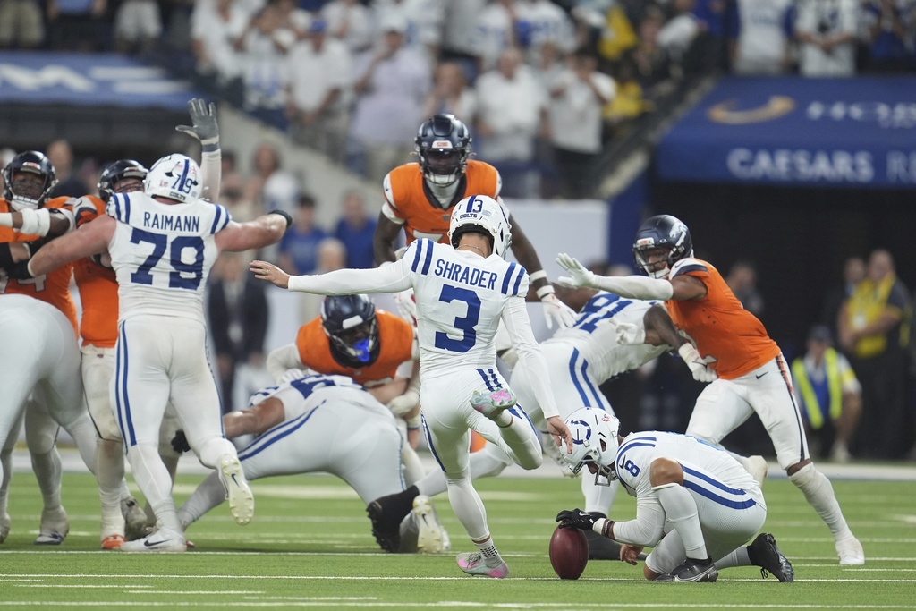 Indianapolis Colts place kicker Spencer Shrader (3) kicks the game winning field goal out of the hold of Rigoberto Sanchez during the second half an NFL football game against the Denver Broncos, Sunday, Sept. 14, 2025, in Indianapolis. (AP Photo/Michael Conroy)