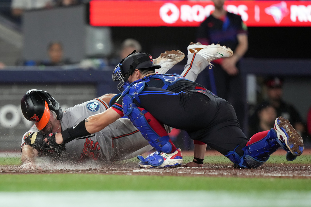 Baltimore Orioles' Pete Alonso (25) is tagged out by Toronto Blue Jays catcher Brandon Valenzuela (59) during eighth inning American League, MLB baseball action in Toronto on Friday, June 5, 2026. (Nathan Denette/The Canadian Press via AP)