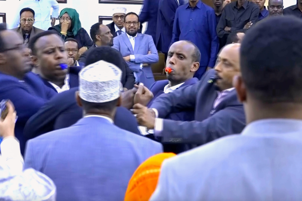 This image taken from an Associated Press video shows a scuffle between lawmakers during a joint session of Somalia's parliament Wednesday, Jan. 28, 2026, in Mogadishu, Somalia. (AP Photo/Mohamud Hassan)